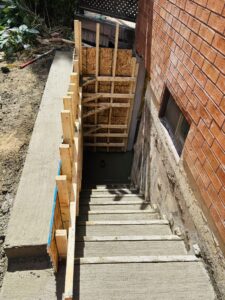 Side entrance basement cost MississaugaBasement walkout with egress window and concrete stairs built by contractor in GTA Ontario