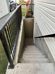 Basement walkout with egress window and concrete stairs built by contractor in GTA Ontario